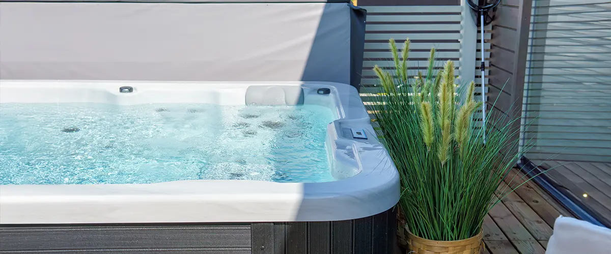 Outdoor hot tub installation with bubbling water, surrounded by natural decor