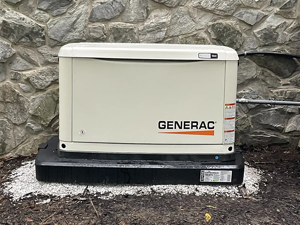 Generac backup generator installed on stone base for reliable emergency home power