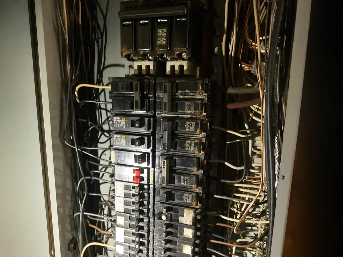 Electrical panel with numerous breakers in need of emergency repair.