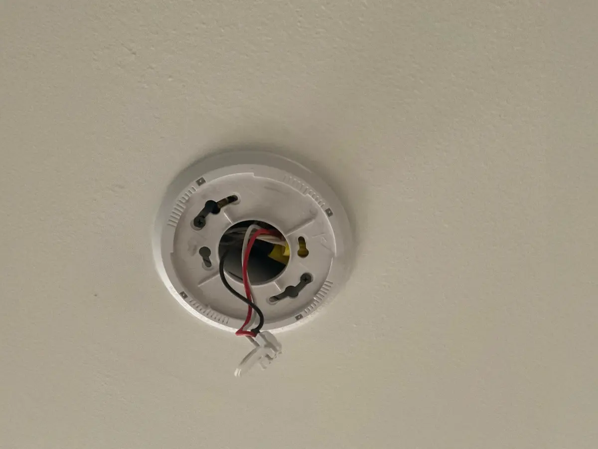 Wiring setup for ceiling smoke detector installation.