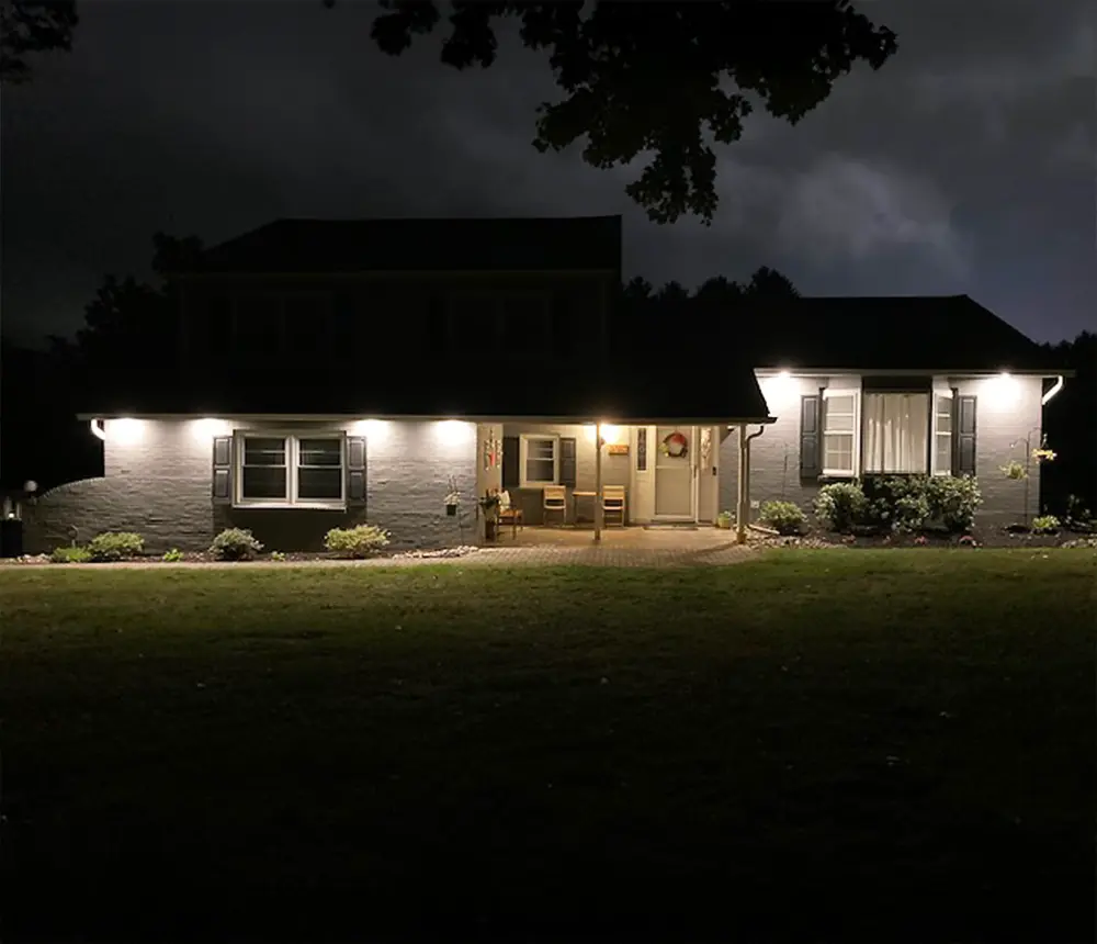 Nighttime exterior lighting on a home, providing safety, visibility, and enhanced curb appeal with professional installation.