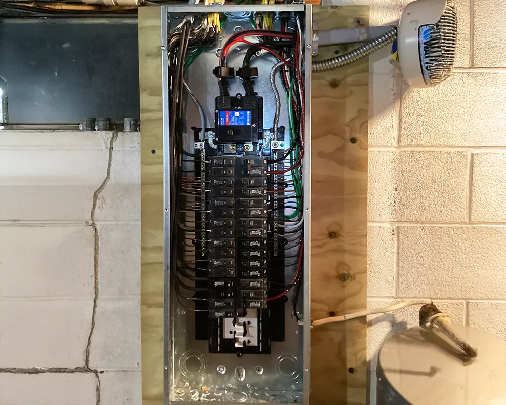 Upgraded breaker panel with organized wiring for improved electrical system safety and efficiency.