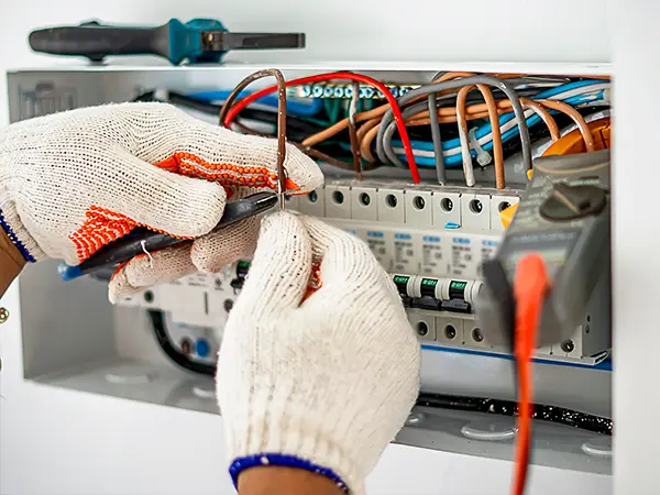 Electrician wiring a breaker panel for home electrical safety and efficiency