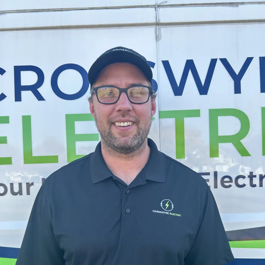 Crosswyre Electric owner standing in front of company van with logo, showcasing local electrical services.